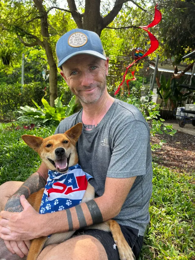 Volunteer comforting a rescued dog at a clinic visit